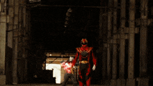 a man in a red and gold costume is standing in front of a lightning bolt