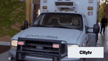 an ambulance with the number 61 on the side of it