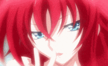 a close up of a person with red hair and blue eyes