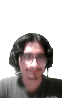 a man wearing glasses and headphones is smiling