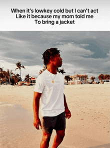 a man standing on a beach with the caption when it 's lowkey cold