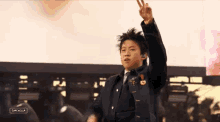 a young man giving a peace sign in front of a screen that says campbella