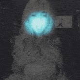 a woman 's face is glowing in the dark with a drawing of a man behind her