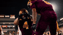 a football player in a maroon uniform with the number 4 on his chest