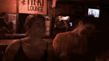 a couple of women are sitting at a table in a bar .