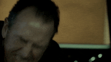 a man 's head is shown in a blurry photo with a yellow background
