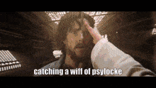 a man with a beard is holding his hand to his forehead and says `` catching a wiff of psylocke ''