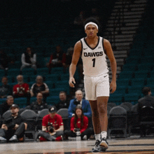 a basketball player for the dawgs is standing on the court