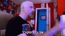 a man in a black shirt is standing in front of a blue door with a makeirmeme.com logo in the corner