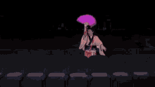 a woman in a kimono is holding a pink fan in a dark auditorium
