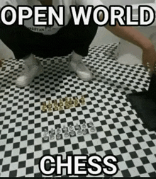 a person is squatting on a checkered floor next to a chess board .