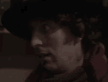 a man is wearing a hat and scarf and says fuck yeah