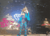 a woman singing on a stage with a sign that says ninja sex party