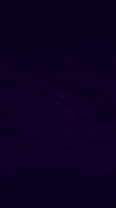 a glowing light is surrounded by flames on a dark background .