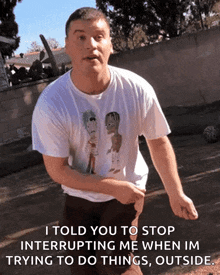 a man wearing a t-shirt that says " i told you to stop interrupting me "