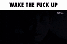 a man with his eyes closed and the words wake the fuck up