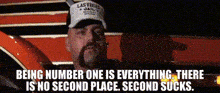 a man wearing a hat that says last vegas jail on it