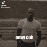 a man wearing sunglasses and a shirt with omw cuh written on it