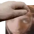 a hand is touching a woman 's forehead in a blurry photo .