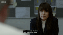 a woman in a suit is talking to a man in front of a bbc logo