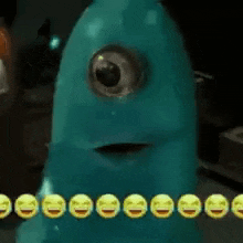 a blue monster with a single eye and smiley faces around it .
