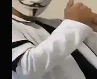 a man wearing a anonymous mask and a tie