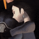 a close up of a cartoon character 's face and arm
