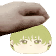 a hand is putting a cartoon character 's head on a white surface .