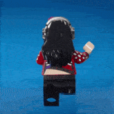 a lego figure is wearing headphones and a red shirt