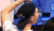 a man wearing a black hat is drinking water