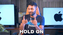 a man in a black shirt with the word hold on on his shirt