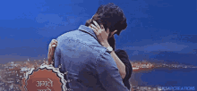 a man and a woman are hugging with a sign that says ruksarcreations in the background