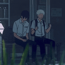 two boys are sitting on a bench and one of them has a backpack on his back