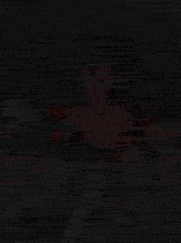a cartoon character with a red shirt and purple gloves is standing in a dark room