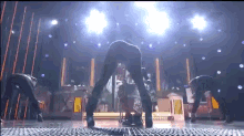 a group of people are dancing on a stage with a watermark that says cnbc