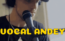 a man singing into a microphone with the name vocal andey written below him