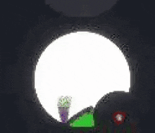 a green cartoon character is sitting in a circle with a red circle with a number 2 on it .