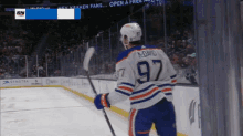 a hockey player with the number 97 on his jersey stands on the ice