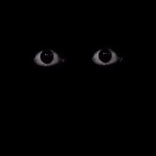 a close up of a person 's eyes glowing in the dark