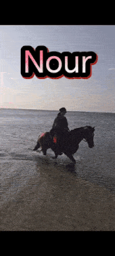 a person riding a horse in the ocean with the name nour written on the bottom