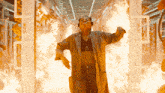 a woman in a lab coat is surrounded by flames and the words tron on the bottom right