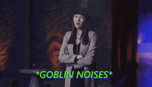 a woman is dancing in a dark room with goblin noises written above her