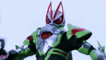 a green and silver superhero with red eyes and ears