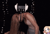 a woman wearing headphones is standing in front of a microphone