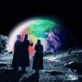 two people looking at a rainbow colored planet