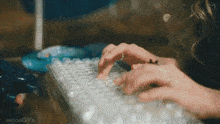 a close up of a person typing on a keyboard with the words aespagifs visible