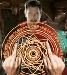 a man is holding a magical circle in his hands and giving a middle finger .