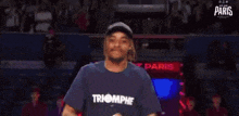 a man wearing a t-shirt that says tomorrow is walking down a red white and blue carpet
