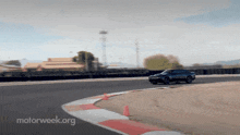 a car is driving on a track with motorweek.org written on the bottom right