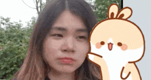 a girl making a face next to a cartoon of a bunny